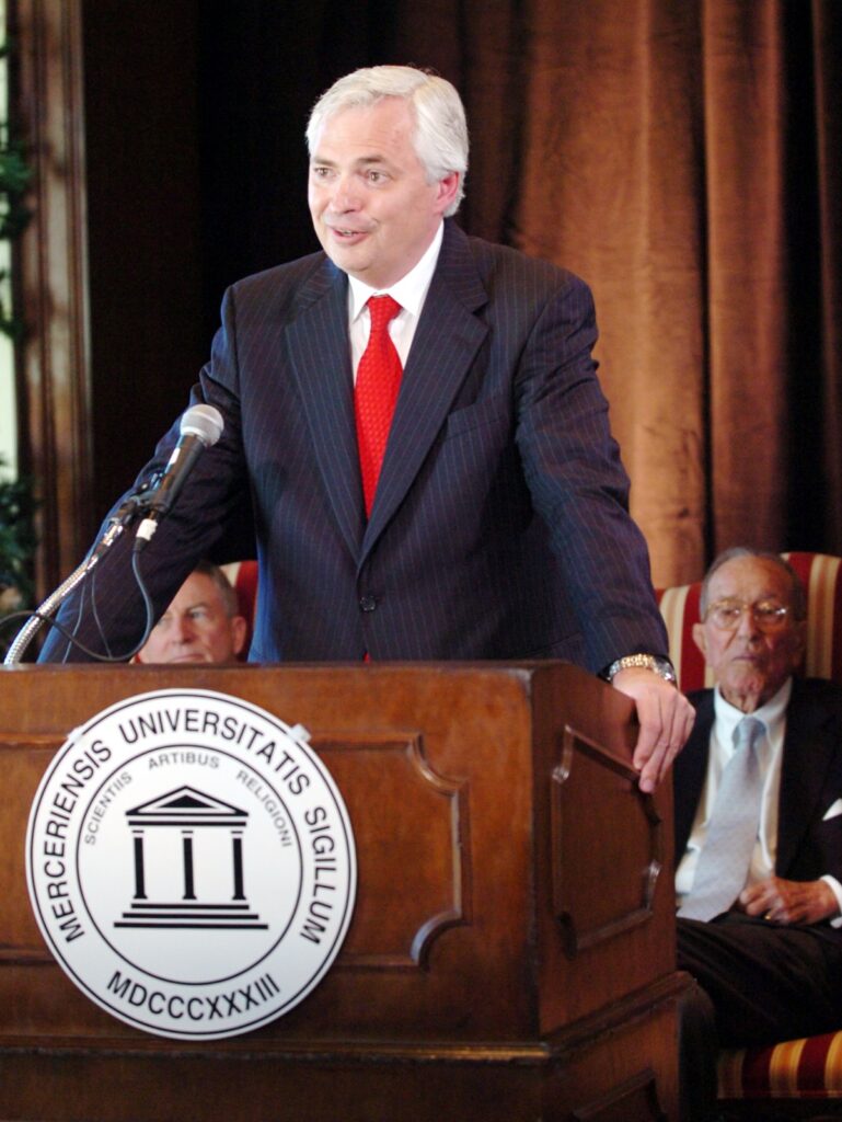 Bill Underwood talks to reporters, flanked by David Hudson left and former attorney general Griffin Bell.