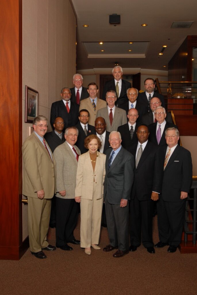 President Underwood standing with individuals at the Carter Center