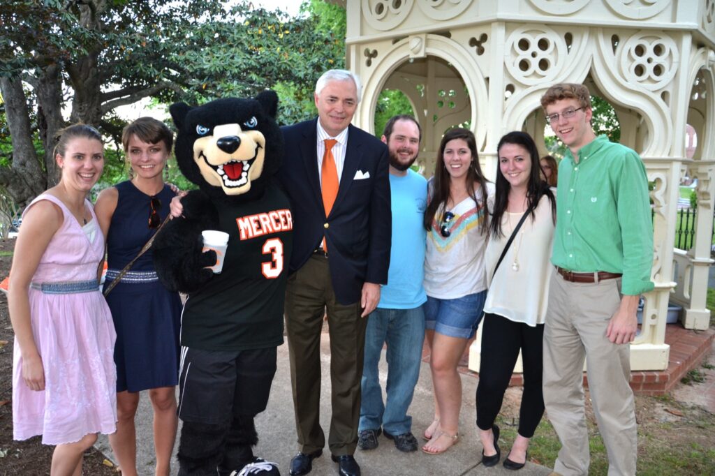 President Underwood standing with Toby and other students