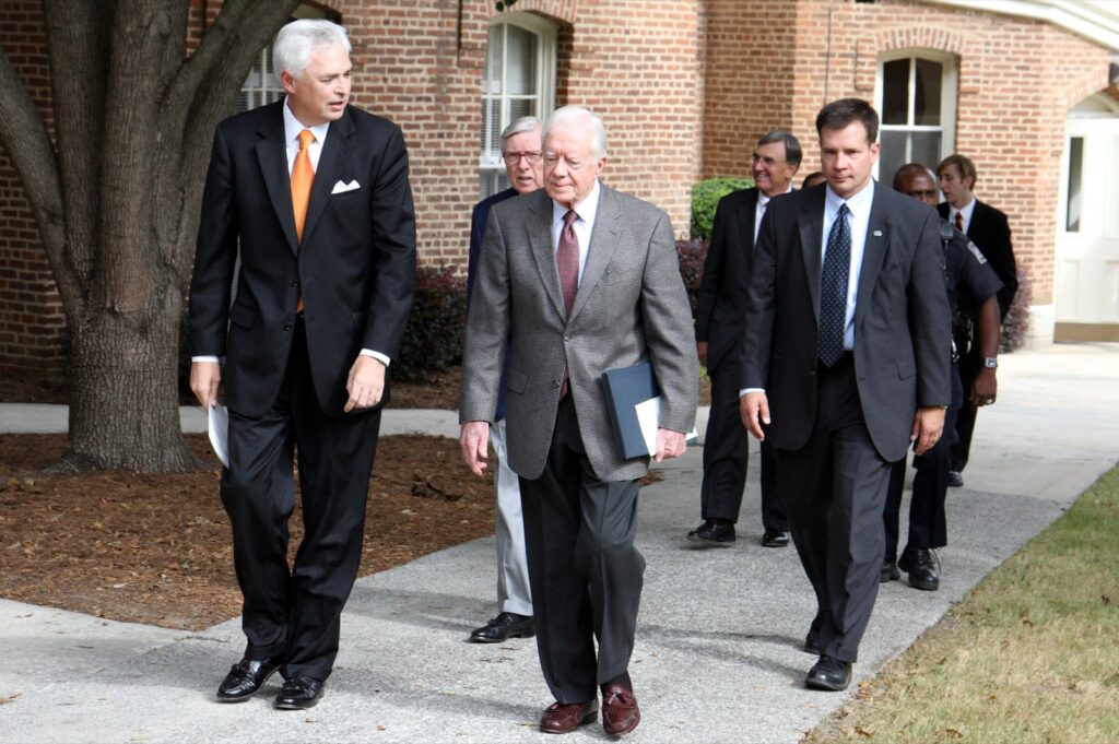 President Underwood walking with President Jimmy Carter and others
