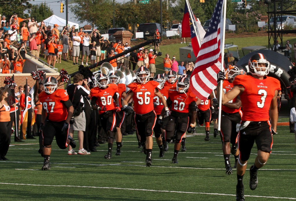 Mercer football players running out on the field