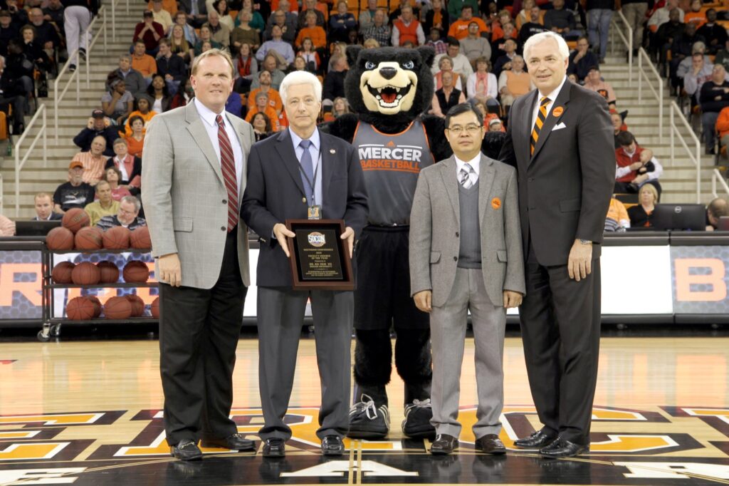 President Underwood standing with faculty member of the year recipient