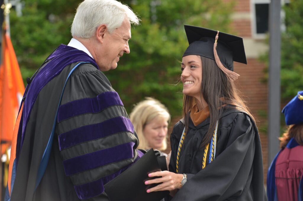 President Underwood shaking a recent graduate's hand