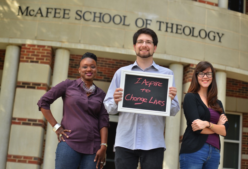 Students holding a sign that reads, "I aspire to change lives"