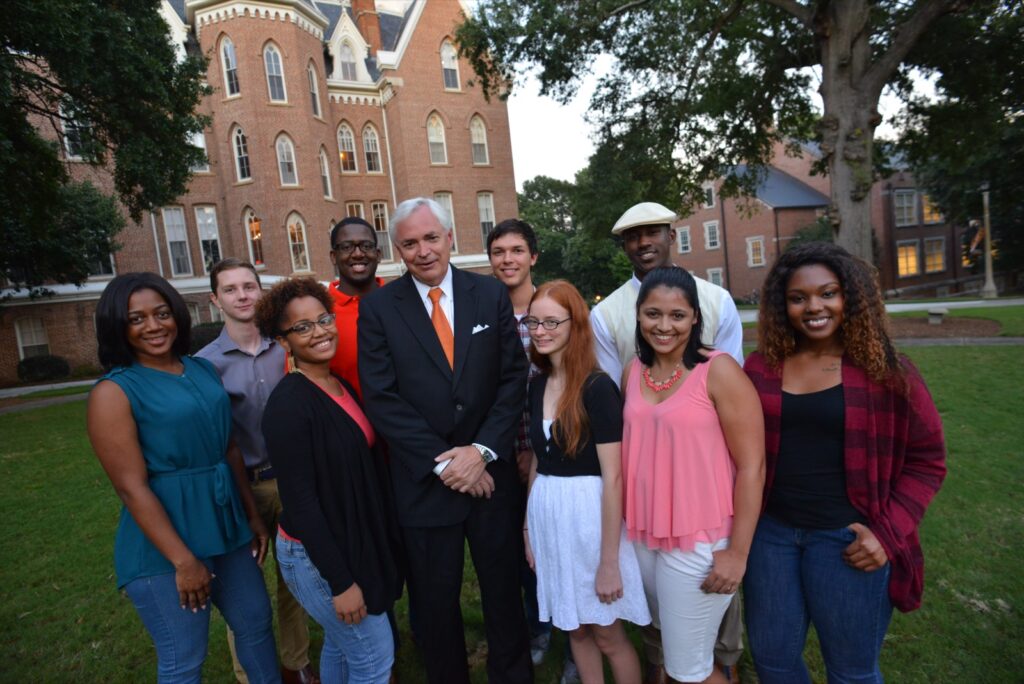 President Underwood standing with a group of students on campus