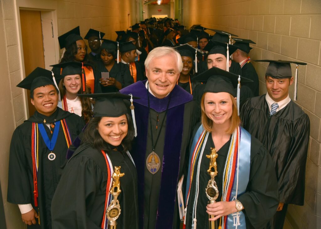 President Underwood standing with students at Commencement